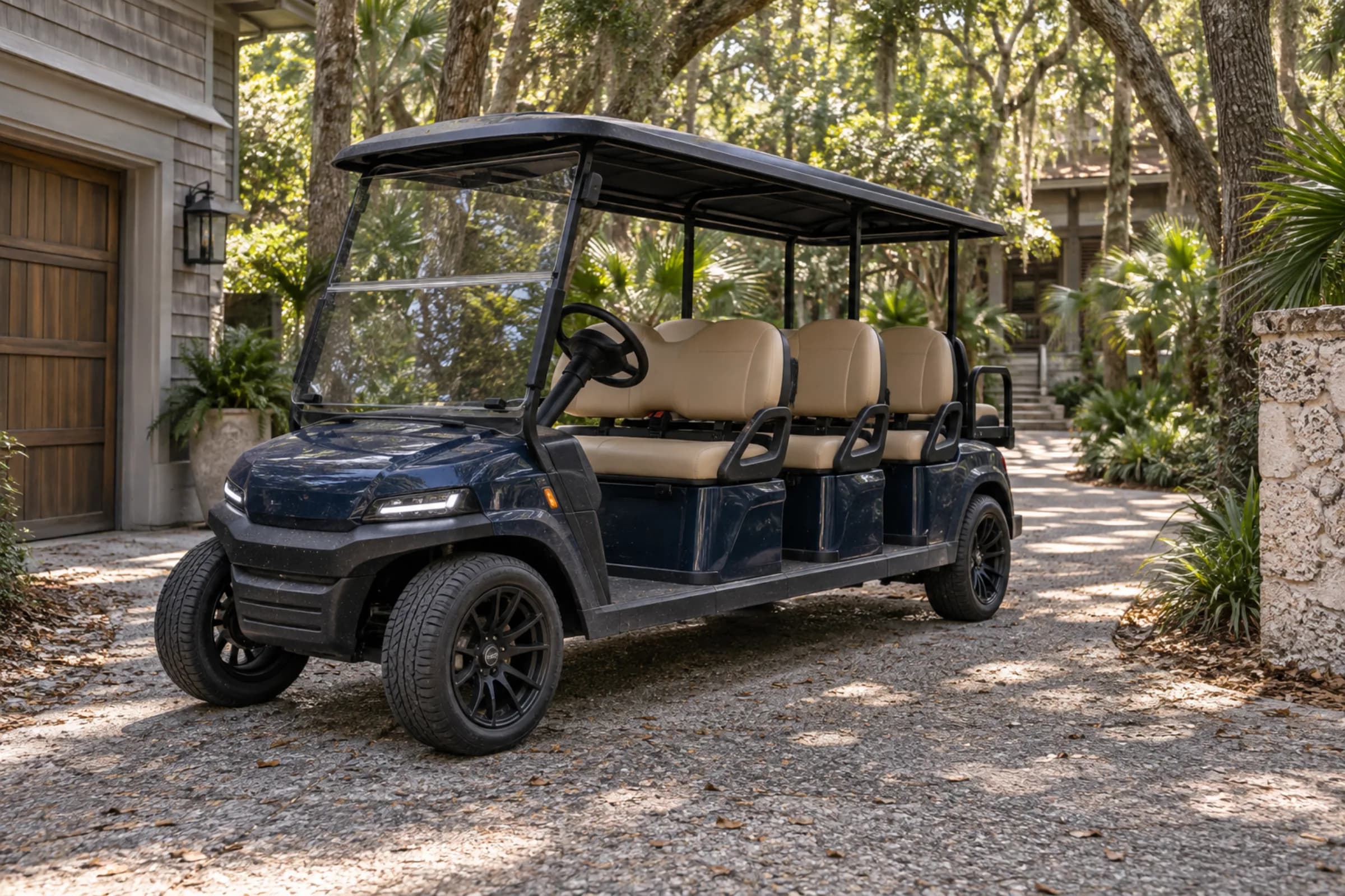 Navy six-passenger golf cart in a wooded Kiawah Island driveway