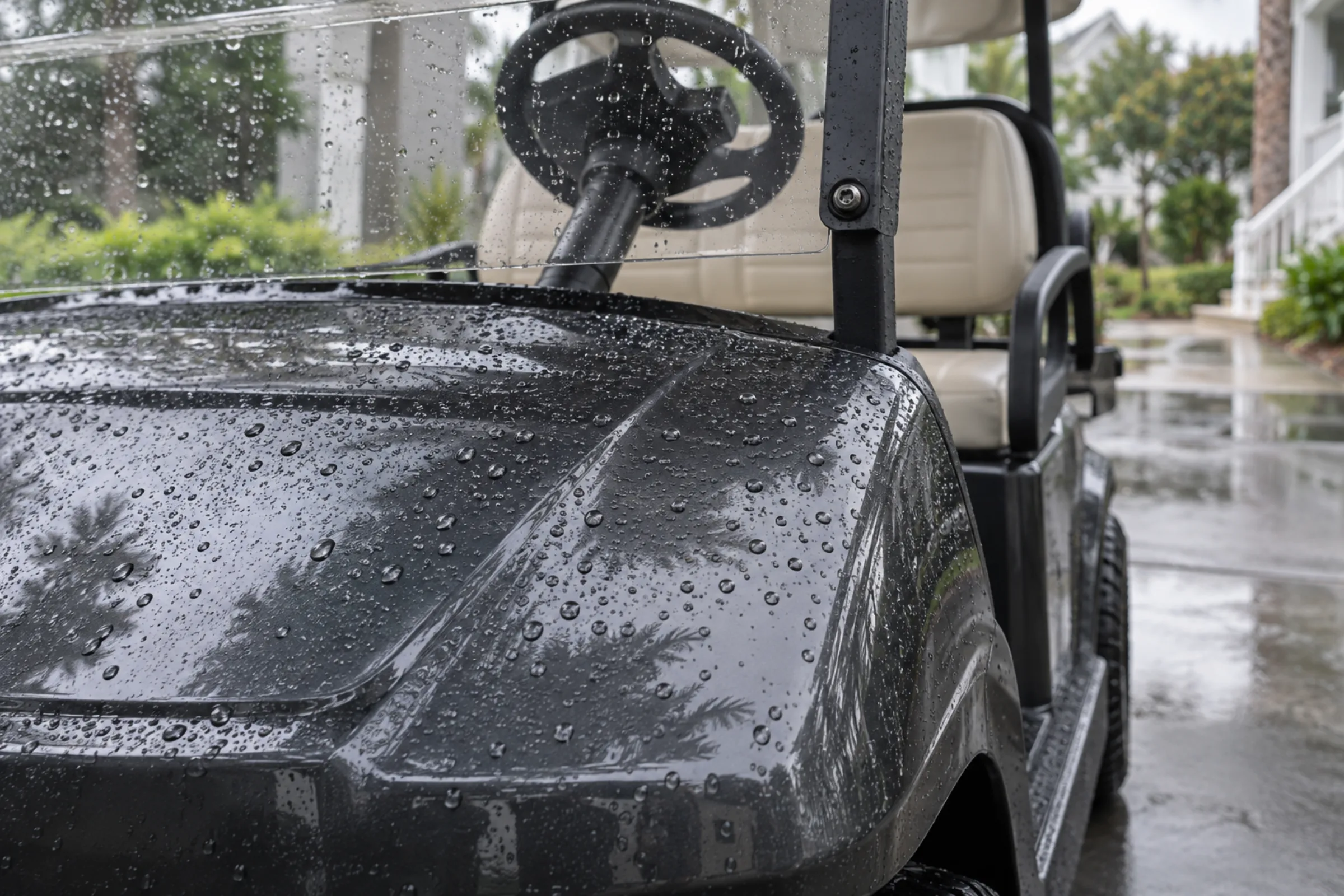 Water beading across the ceramic-coated front cowl of a golf cart