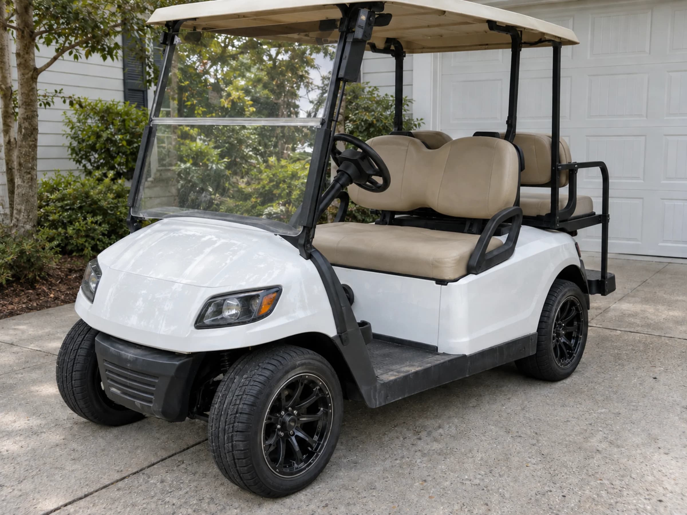 Same white golf cart with an even restored finish after paint correction