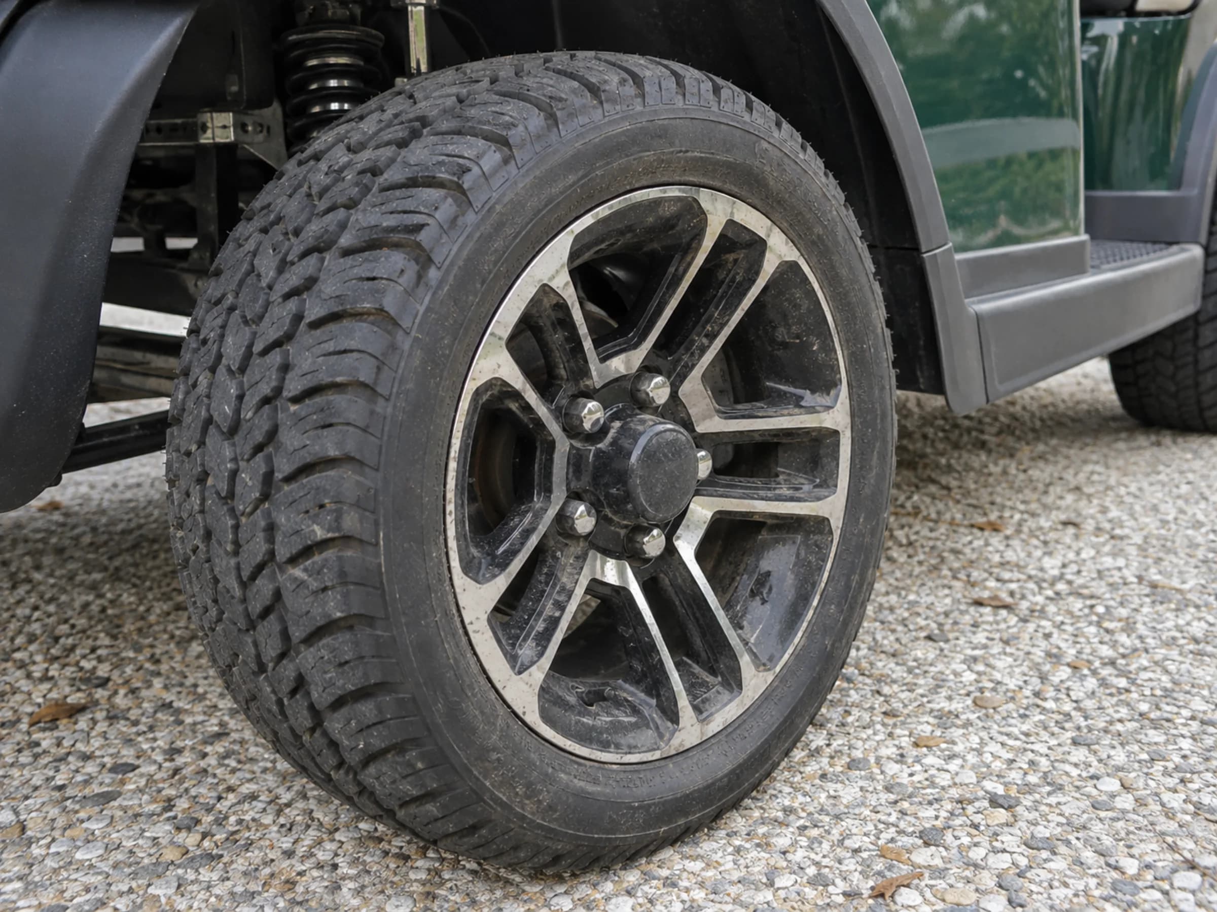 Golf cart alloy wheel carrying brake dust, road grit, and salt deposits